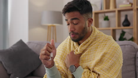 man, sick and blowing nose with tissue on sofa