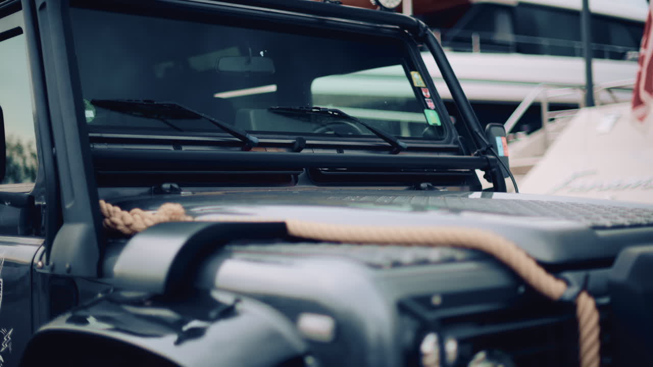 Close up of a rugged off road vehicle with a thick rope across its hood