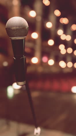 close-up of a microphone on a stage with blurry lights in the background