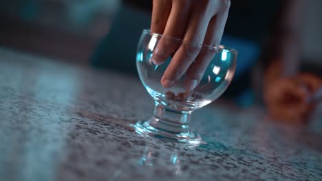 putting chocolate cookie crumbles inside a glass