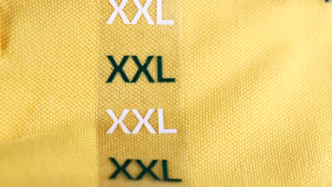 xxl size tag on a yellow polo shirt