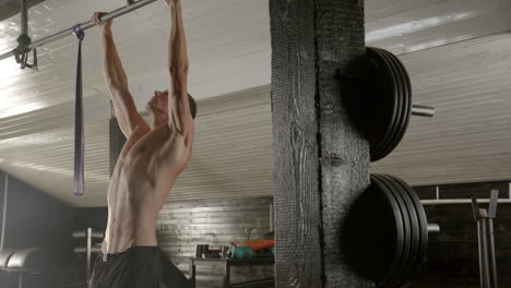 man doing pull-ups in a gym