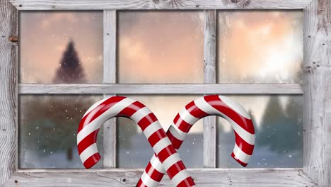 Animation-Von-Weihnachtsdekorationen-Mit-Zuckerstangen-Und-Einer-Winterlandschaft,-Die-Durch-Das-Fenster-Gesehen-Wird