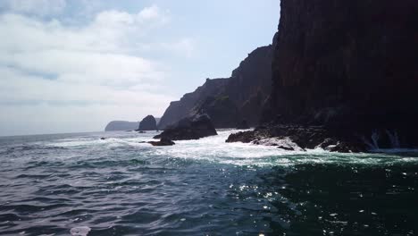 handheld slow motion shot from a boat of the rugged east anacapa island coastline at channel islands national park in the pacific ocean