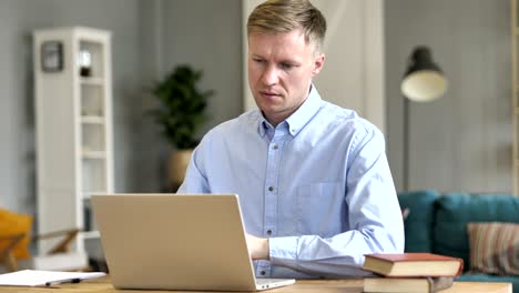 businessman typing on laptop in office