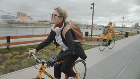 girl with prosthetic arm riding bicycle in city