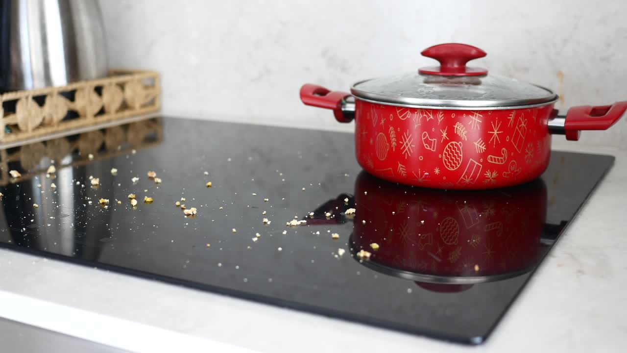 Red Pot On A Dirty Stovetop
