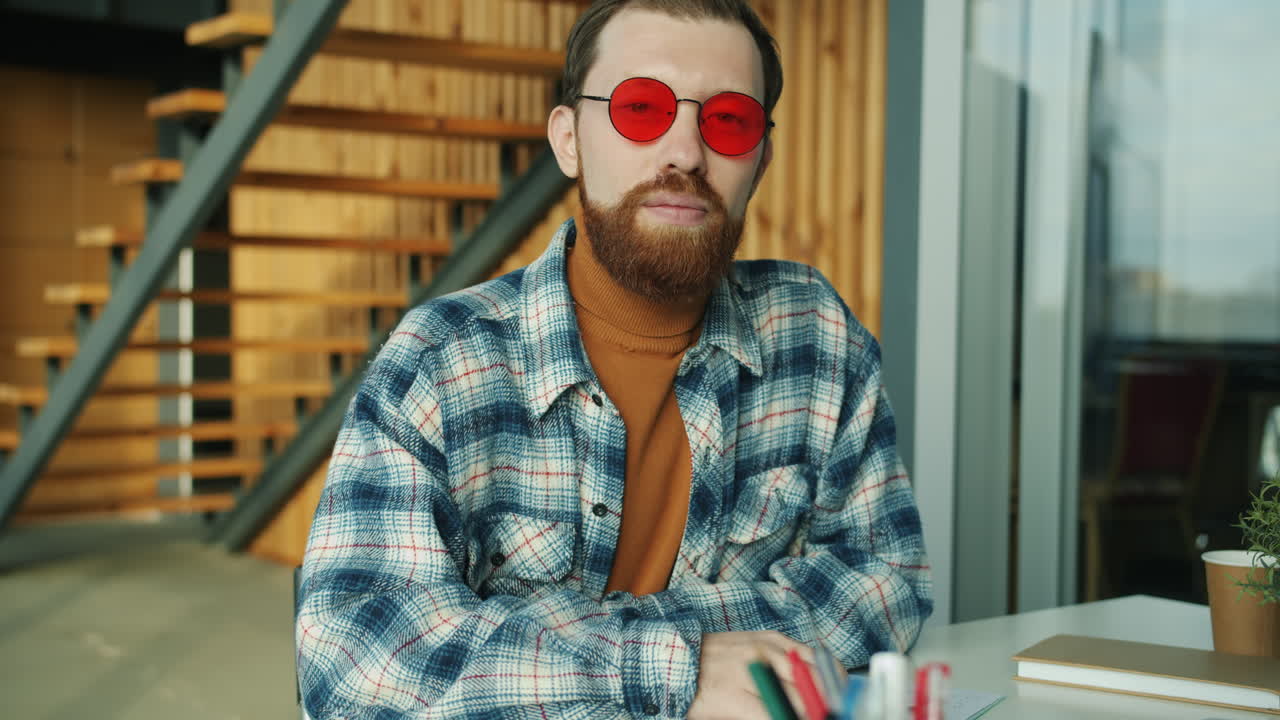 Man in Red Sunglasses at a Modern Office