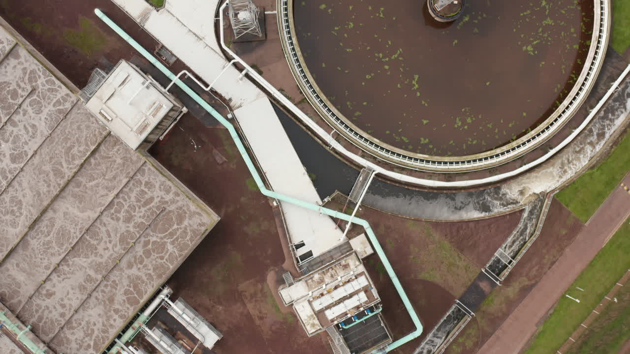 Aerial shot of a sewage plant following the rushing water through the process