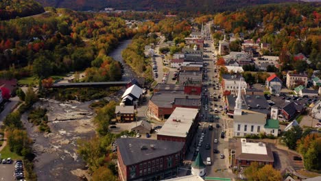 New-England-town-with-covered-bridge-during-autumn-fall-foliage-season