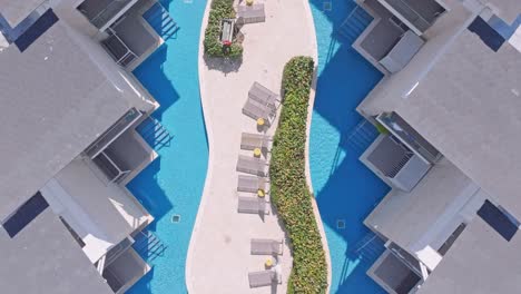 top down aerial modern hotel rooms with balcony to swimming pool, luxury