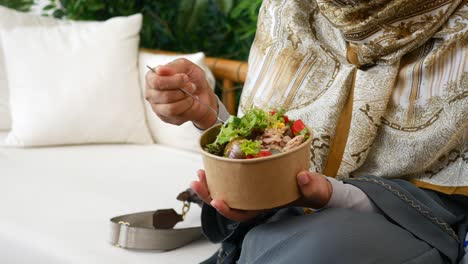 woman eating a tuna salad bowl