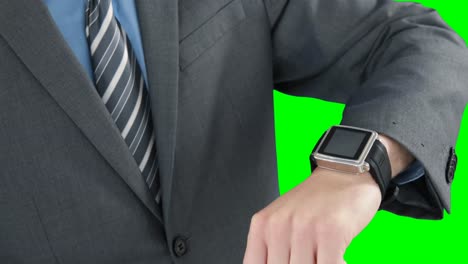 Mid-section-of-businessman-using-smart-watch