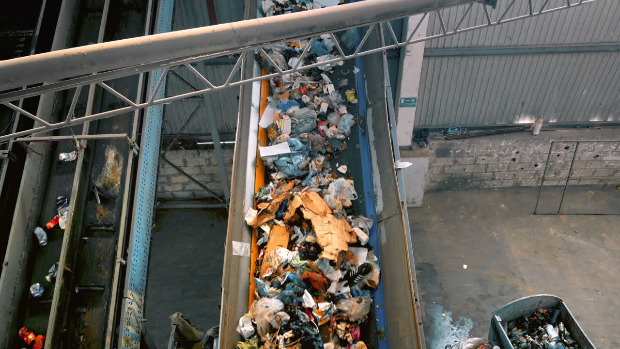 Garbage moving on a conveyor belt at waste sorting plant