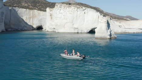 Three-Young-Adults-on-Boat-Trip-Aerial-Follow-Shot