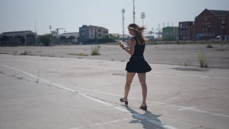 woman walking in empty industrial lot
