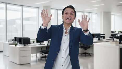 Happy-Indian-businessman-waving-hello