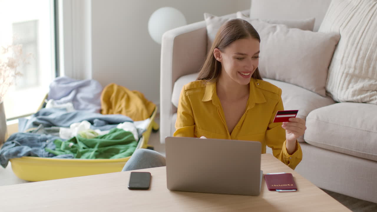 Woman online shopping and packing for a trip