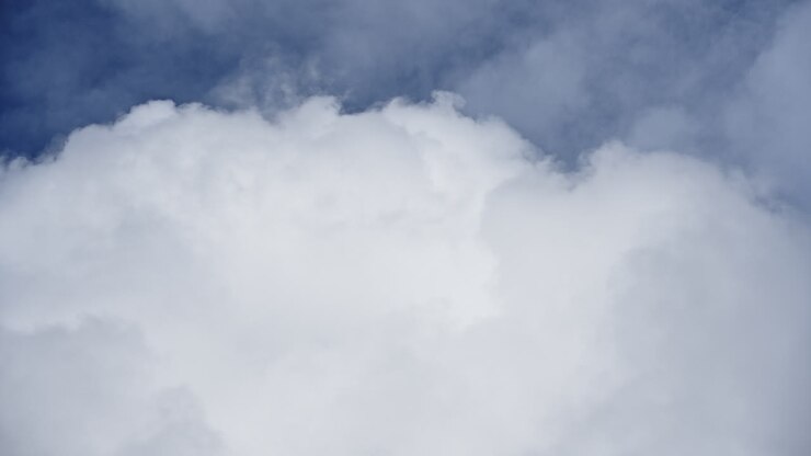 Vast expanse of billowing white clouds against a blue sky, captured in a timelapse