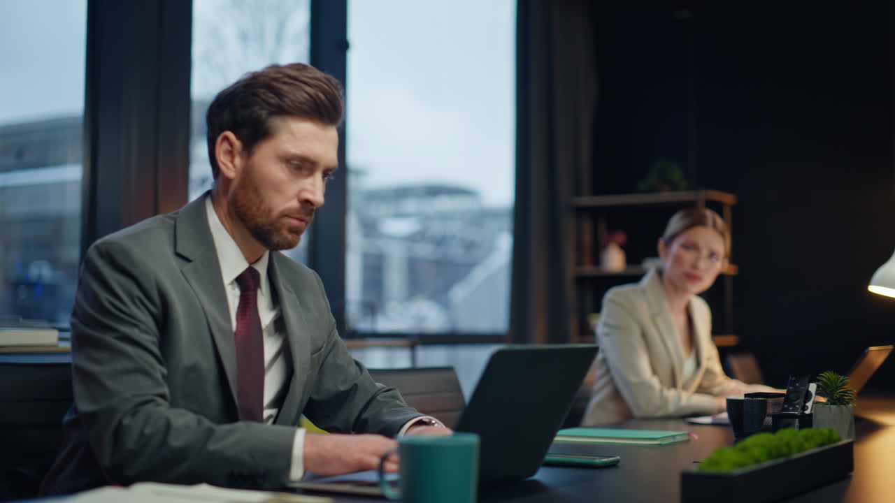 Evening manager reacting fail looking man coworker at open space office closeup