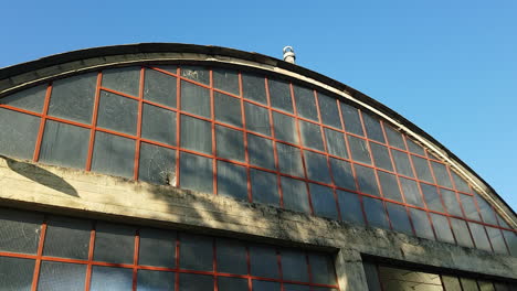 tilt down shot of a old asbestos industrial hangar at a sunny day. sieci, pontassieve. italy