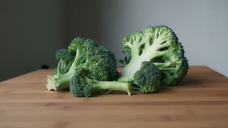 Bright-and-Fresh,-Slow-Push-in-to-Sliced-Raw-Broccoli-on-Light-Wooden-Tabletop