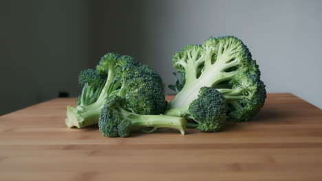 bright and fresh, slow push-in to sliced raw broccoli on light wooden tabletop