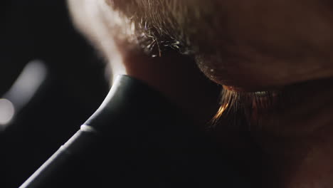 male lab technician looks into the eyepiece of the microscope 2