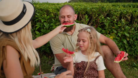 family picnic in a tea plantation with watermelon