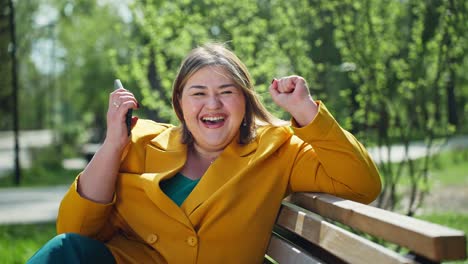 Plus-size woman celebrating outdoors