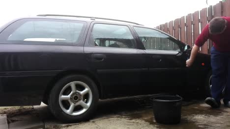 Time-lapse-of-man-washing-an-old-car