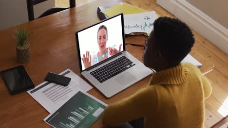 Afroamerikanische-Frau-Nutzt-Laptop-Bei-Videoanruf-Mit-Einer-Kollegin,-Die-Von-Zu-Hause-Aus-Arbeitet