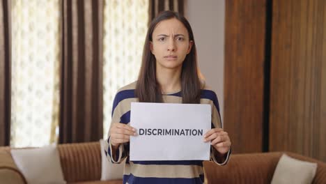 angry indian woman holding discrimination banner