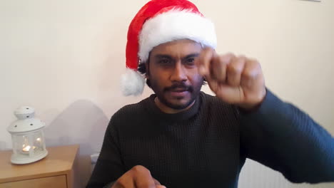 Young-Man-On-Christmas-Video-Call-Acting-Out-Word-During-Charades-Game