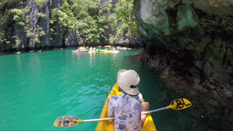 Girl-kayaking-on-yellow-boat-in-Big-lagoon-in-Philippines