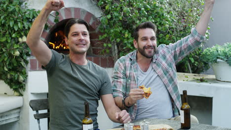 friends enjoying pizza and beer outdoors