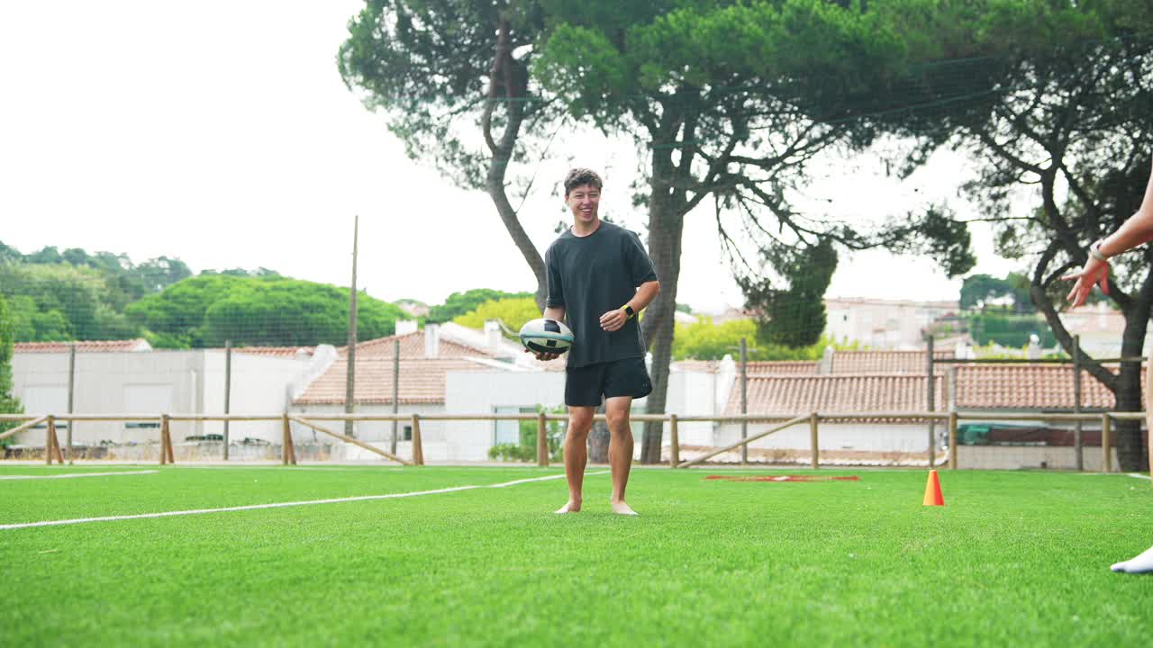 People playing rugby on grass field