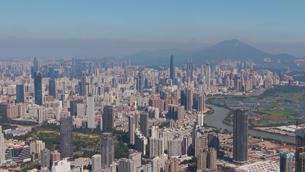 Fly by drone shot of Shenzhen’s skyline, river, and borderlands near Hong Kong, blending modern towers with lush wetlands. Ideal for urban, geography, and travel projects. China, UHD