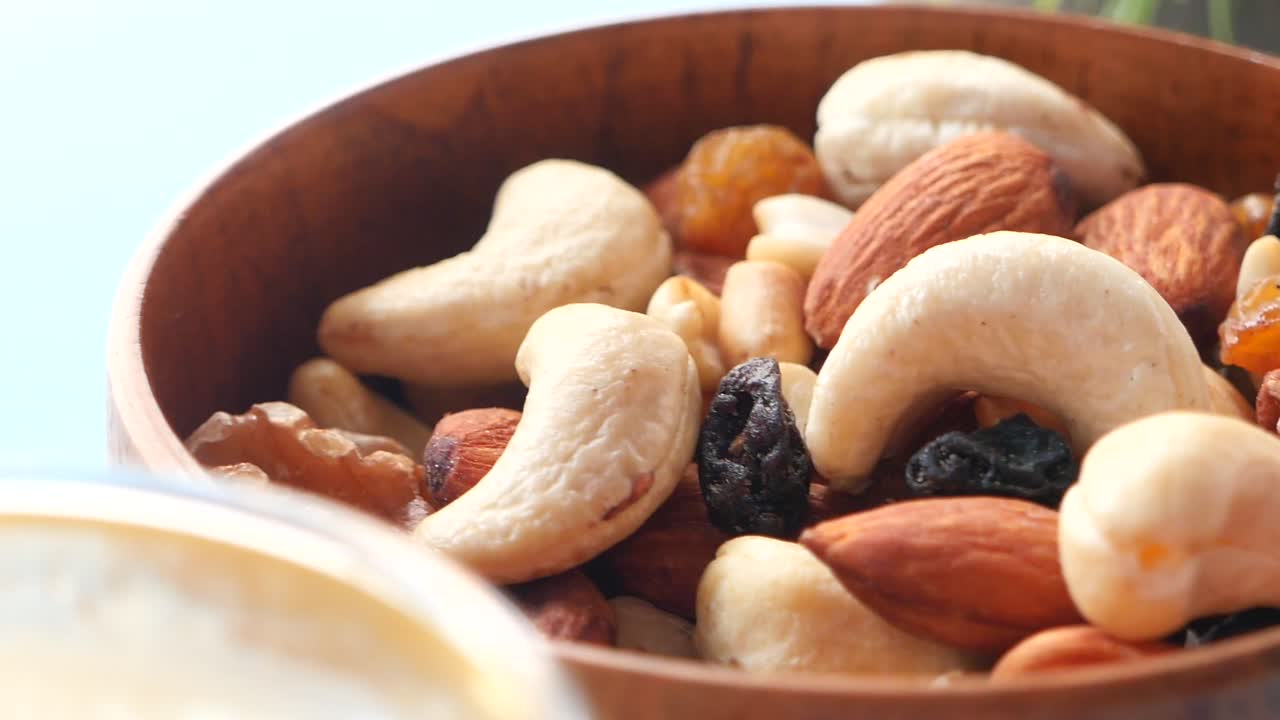 Mixed Nuts and Raisins in Wooden Bowl