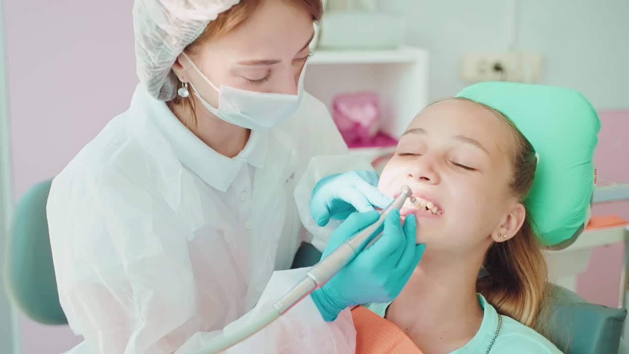 Dentist Cleaning Teeth of a Child
