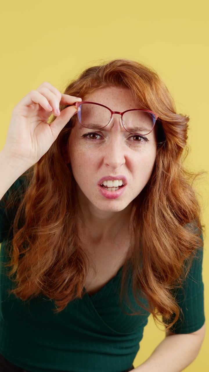 Redhead Woman with Glasses Showing a Confused or Disgusted Expression