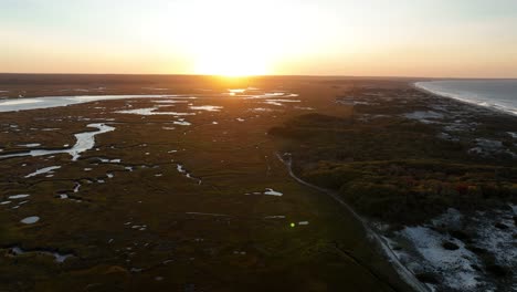 scenery of salt marsh and sand dunes at sunset, cape cod, barnstable, massachusetts - drone shot