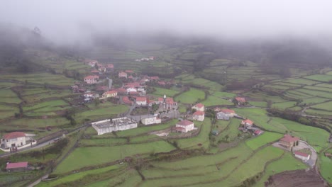 Small-village-Sobrada-Portugal-between-terraces-during-moody-day,-aerial