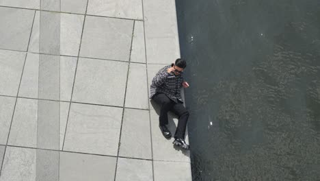 Young-Asian-male-wearing-casual-attire-and-posing-pool-side