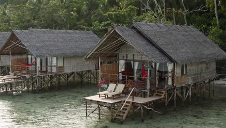 drone captures cozy beach house nestled along the indonesian coastline