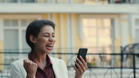 Smiling-businesswoman-having-video-chat-outside.-Lady-looking-phone-screen