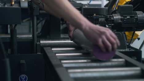 Workman-Puts-Bar-on-Desk-with-Spinning-Rollers