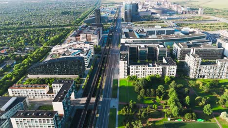 scenic aerial view over orestad metro line in green residential area, denmark