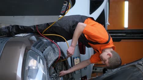 a mechanic performing maintenance or repair on a car in a garage