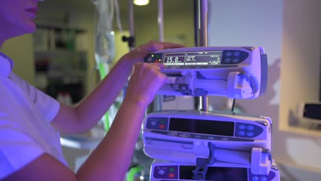 Nurse-in-white-coat-interacting-with-medical-equipment-in-clinic